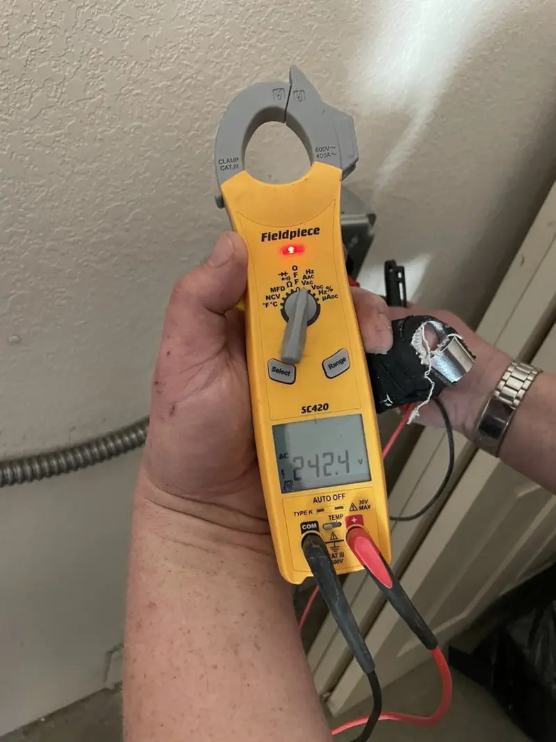 Voltage testing with clamp meter during Electrical Installation Services in Metter